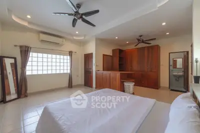 Spacious bedroom with modern ceiling fans and ample natural light