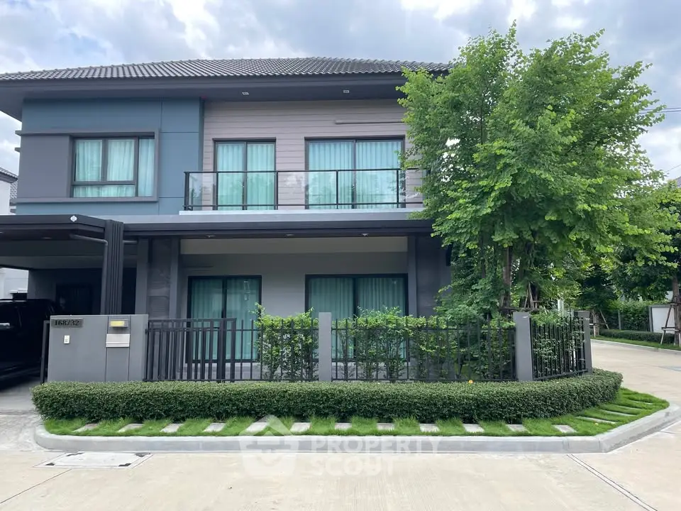 Modern two-story house with lush landscaping and sleek design in a serene neighborhood.