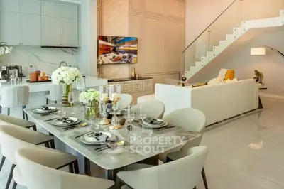 Luxurious open-plan living room with elegant dining area and modern staircase.