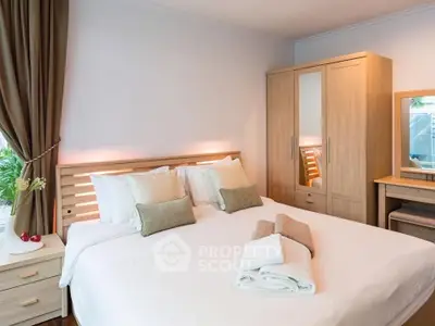 Cozy bedroom with modern wooden furniture and soft lighting, perfect for relaxation.