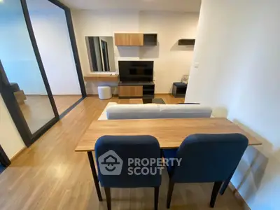 Modern living room with sleek furniture and wooden flooring, perfect for cozy gatherings.