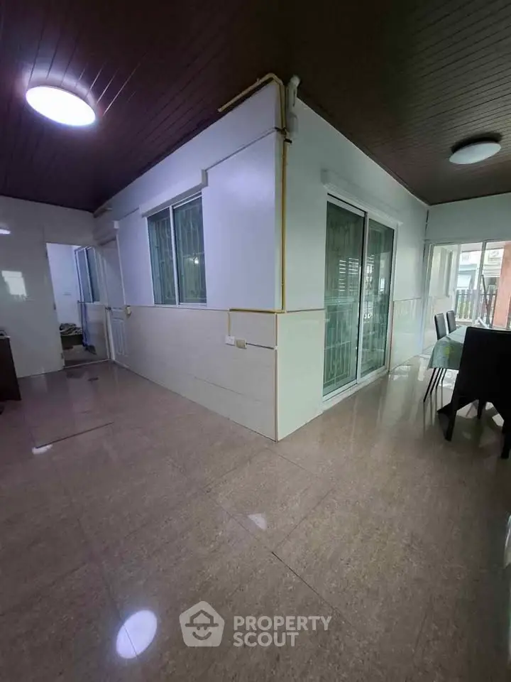 Spacious interior with tiled flooring and large windows in a modern home.
