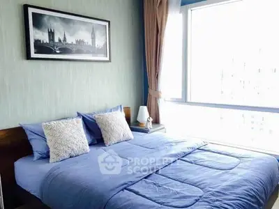 Cozy bedroom with large window and stylish decor in modern apartment.