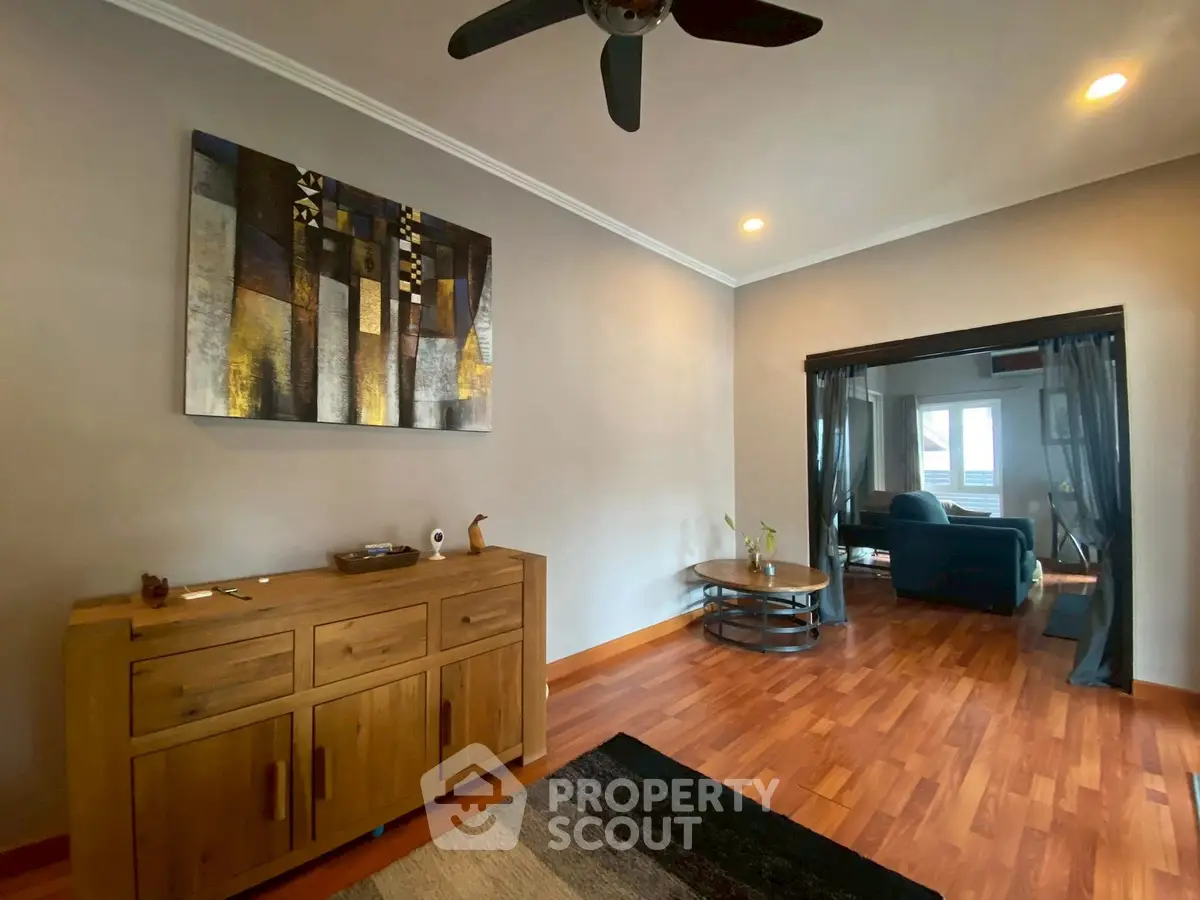 Spacious living room with modern decor and wooden flooring