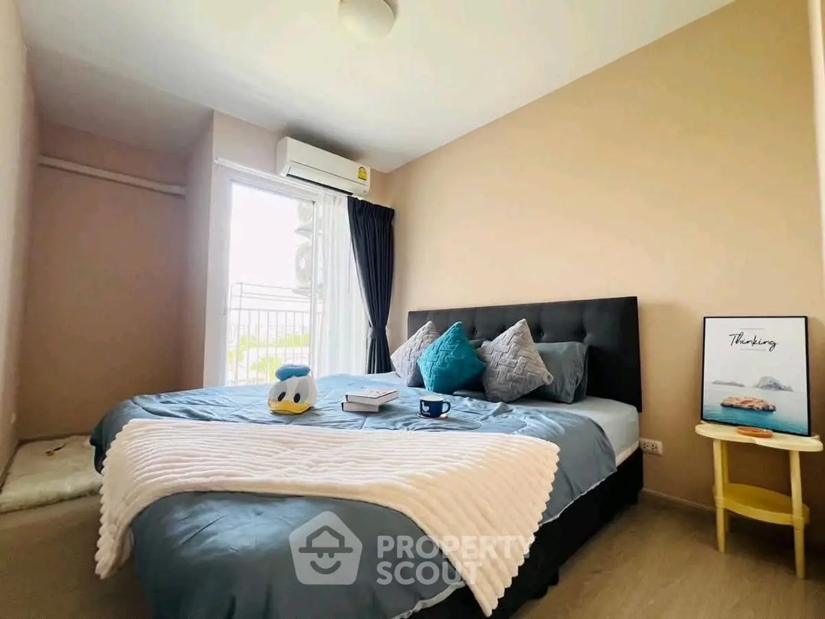 Cozy bedroom with modern decor and natural light, featuring a plush bed and stylish accents.