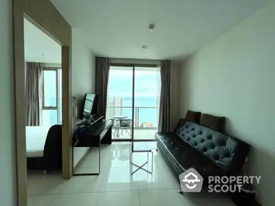 Modern living room with balcony and ocean view in high-rise apartment