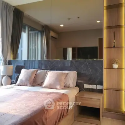 Luxurious bedroom with elegant decor and large window offering natural light.