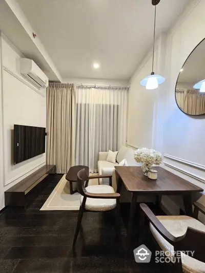 Elegant dining and living space with polished dark marble floors, modern furniture, and tasteful decor, perfect for sophisticated urban living.