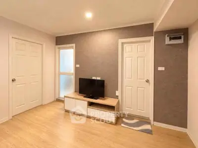 Modern living room with wooden flooring and stylish TV unit