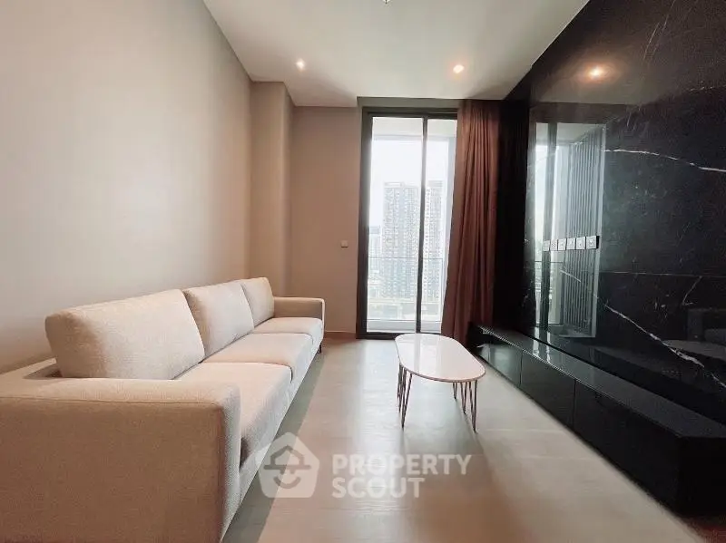 Modern living room with sleek design and city view from large window.