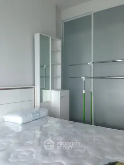 Modern bedroom with sleek wardrobe and minimalist decor