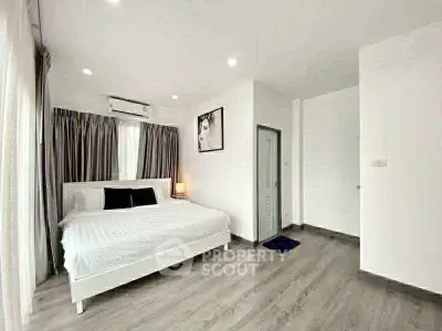 Spacious modern bedroom with elegant decor and natural light