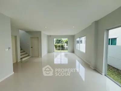 Spacious and bright living room with large windows and modern design