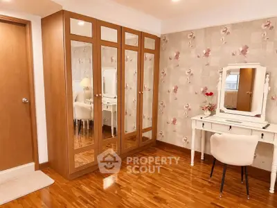 Elegant bedroom with mirrored wardrobe and stylish vanity set