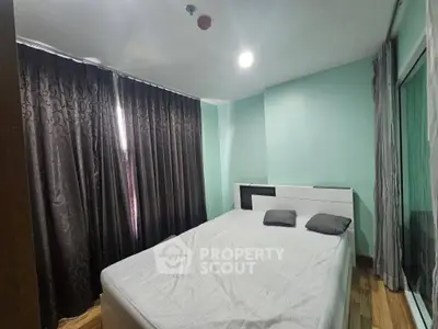 Cozy bedroom with modern decor and ample natural light, featuring a comfortable bed and elegant curtains.