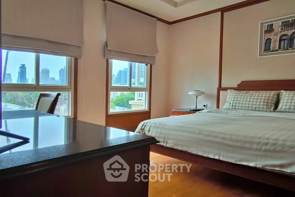 Spacious bedroom with city view and elegant furnishings in modern apartment