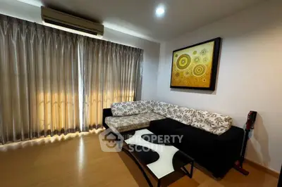 Stylish living room with modern L-shaped sofa and abstract art, featuring elegant curtains and wooden flooring.