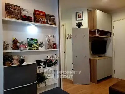 Cozy living room with modern decor and built-in shelving, perfect for relaxation and entertainment.