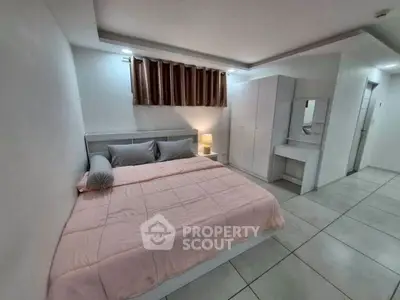 Spacious modern bedroom with elegant decor and ample storage space.