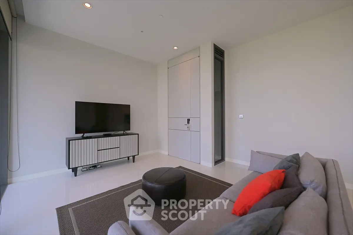 Modern living room with sleek TV stand and cozy seating area