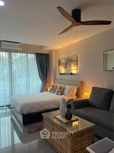 Modern bedroom with stylish decor, large windows, and cozy seating area in a luxurious apartment.