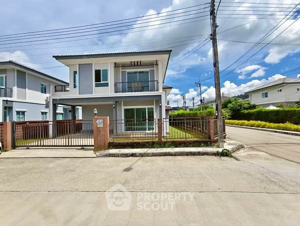 Modern two-story house with spacious yard and driveway in a serene neighborhood.
