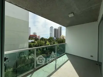 Spacious balcony with city skyline view and lush greenery