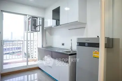 Modern kitchen with balcony view in high-rise apartment