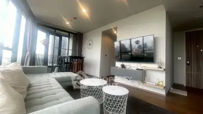 Modern living room with stylish decor and city view balcony