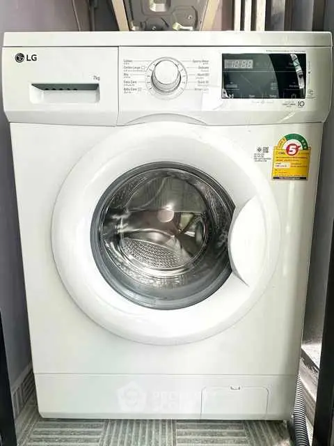 Modern LG washing machine in a sleek laundry area, perfect for efficient home living.