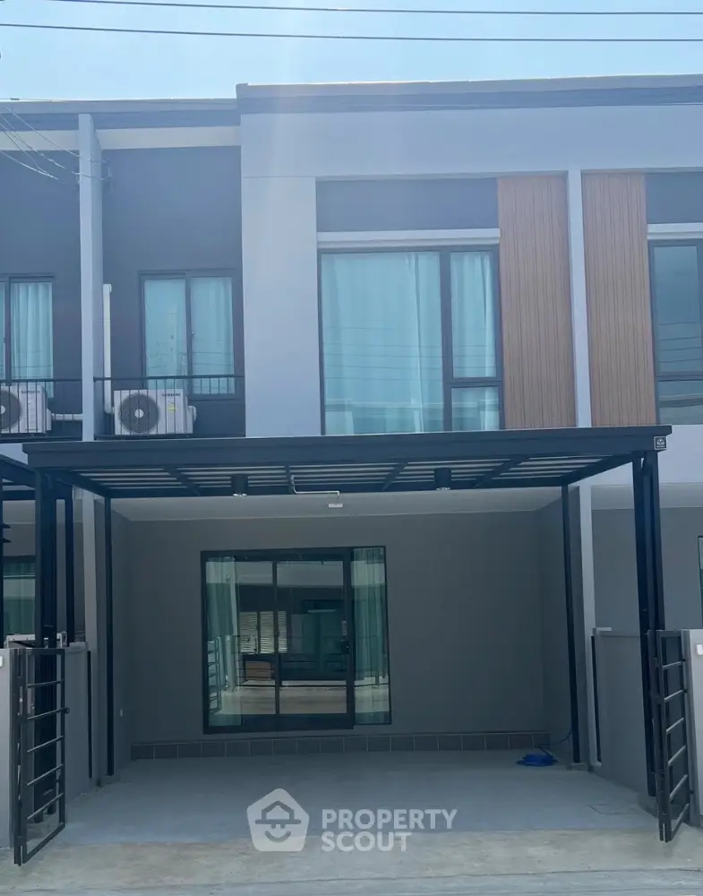 Modern townhouse exterior with sleek design and large windows