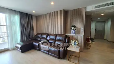 Modern living room with leather sofa and elegant decor in high-rise apartment.