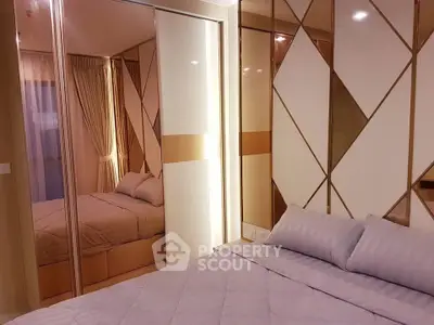 Luxurious bedroom with mirrored wardrobe and elegant decor