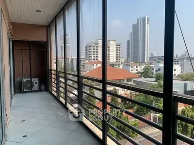 Spacious balcony with city view in modern apartment building