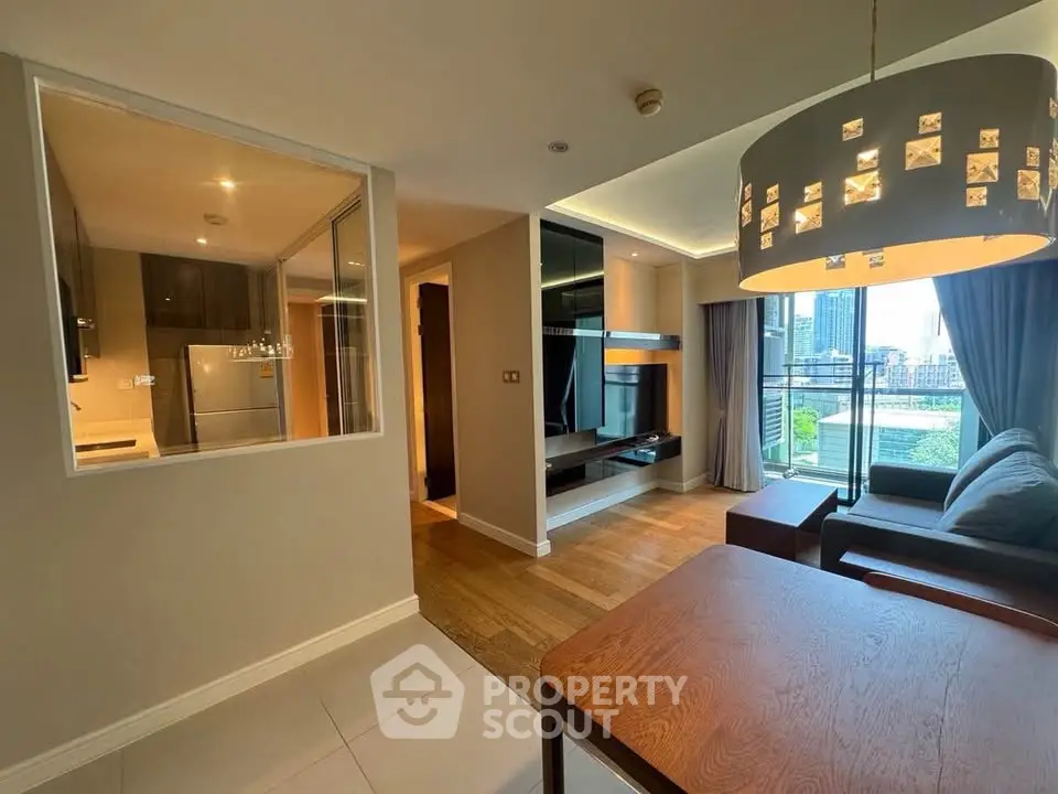 Modern open-plan living room with city view and stylish lighting