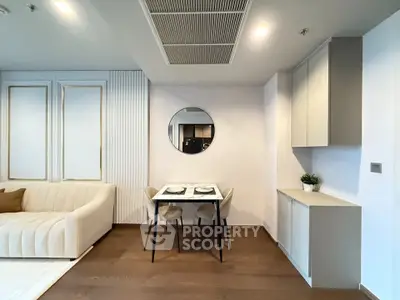 Modern living room with stylish decor and dining area in a contemporary apartment.