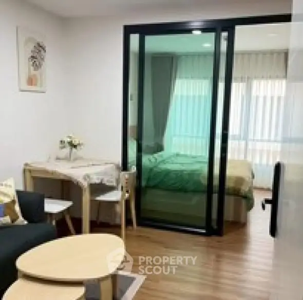 Modern studio apartment with sliding glass partition and cozy decor