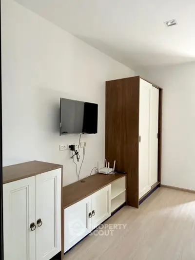 Modern living room with sleek TV setup and stylish storage cabinets