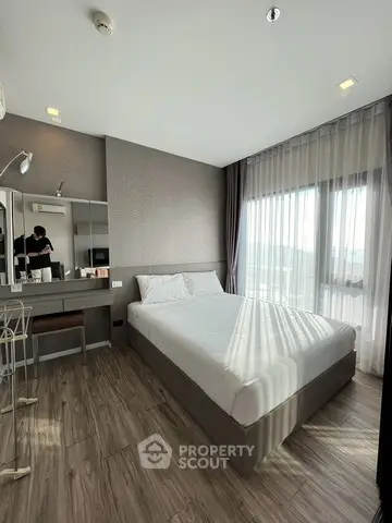 Modern bedroom with large window and stylish decor