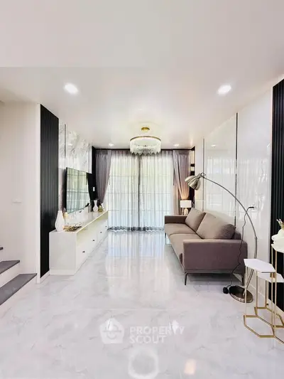 Elegant modern living room with marble flooring and chic chandelier
