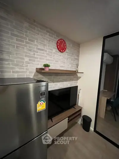 Modern living room with sleek fridge and stylish decor
