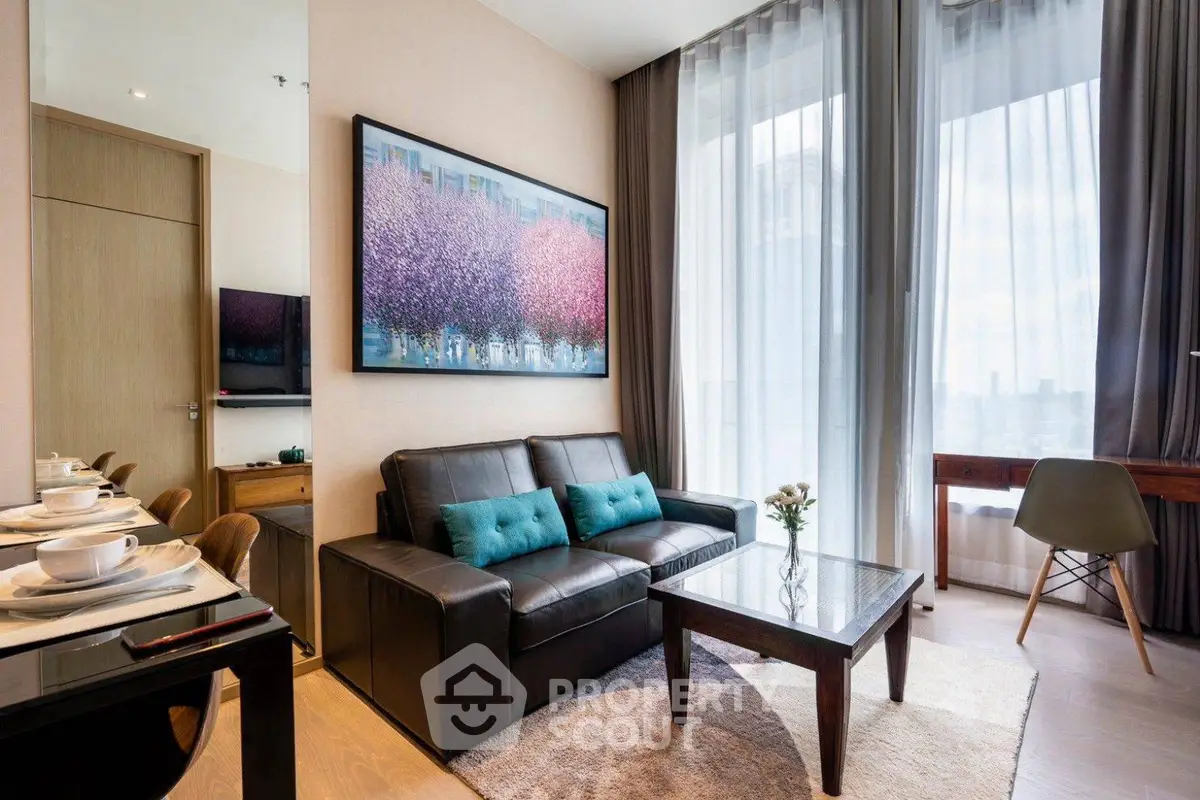 Modern living room with stylish decor and large window offering city views.