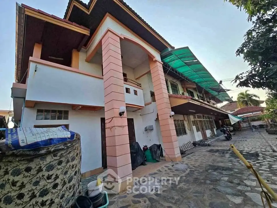 Spacious two-story house with unique architectural design and ample outdoor space.