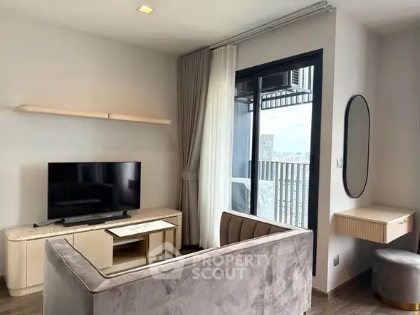 Modern living room with sleek furniture and balcony view in a stylish apartment.