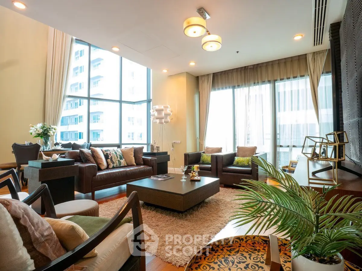 Luxurious living room with modern decor and large windows offering city views.