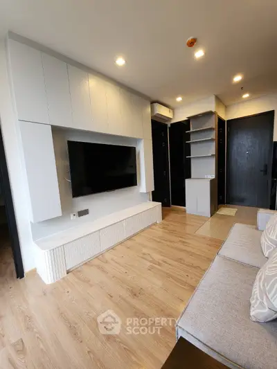 Modern living room with sleek design, featuring a wall-mounted TV and stylish storage solutions.