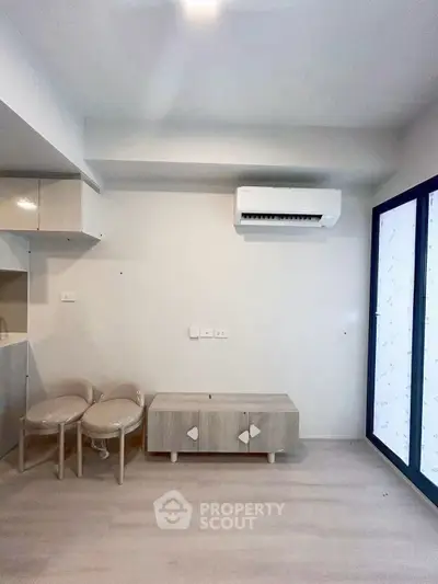 Modern minimalist living room with air conditioning and sleek furniture