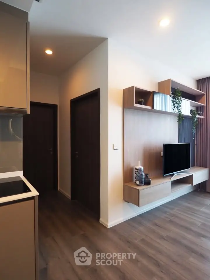 Modern living room with sleek wooden flooring and stylish TV unit
