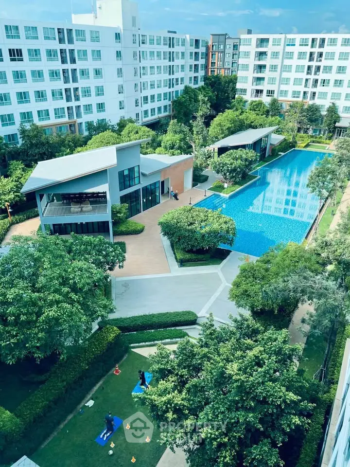 Luxurious condominium with pool and lush gardens offering serene living environment.
