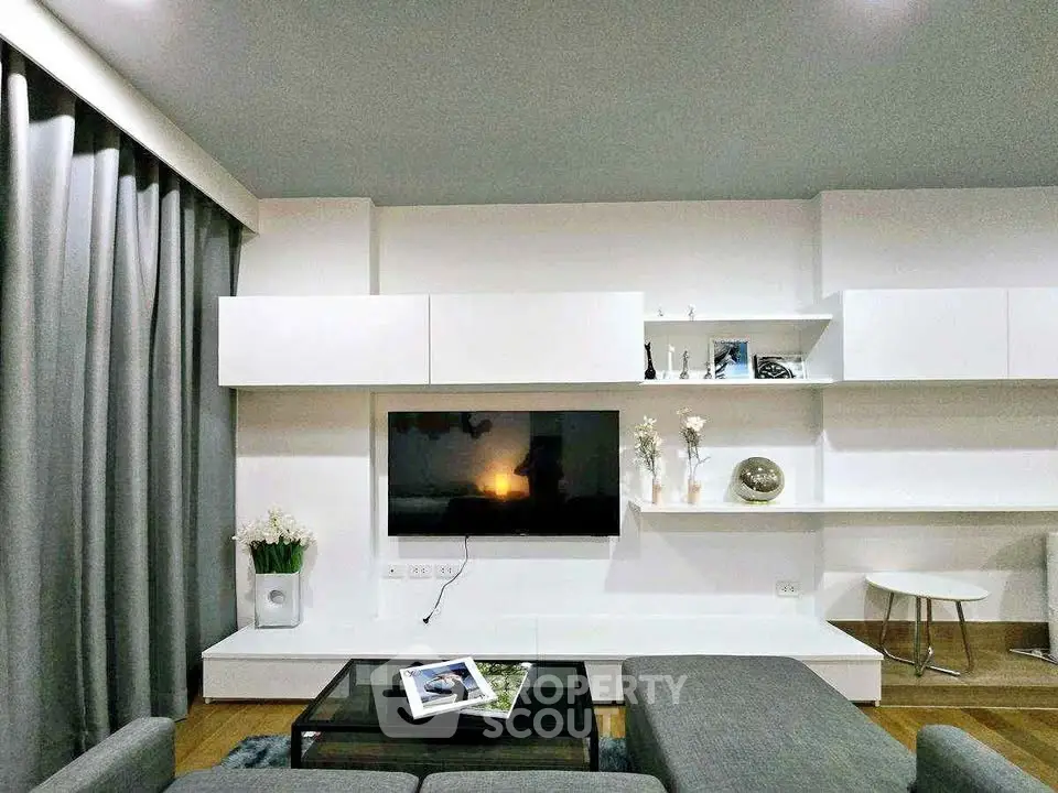Modern living room with sleek white shelves and stylish decor